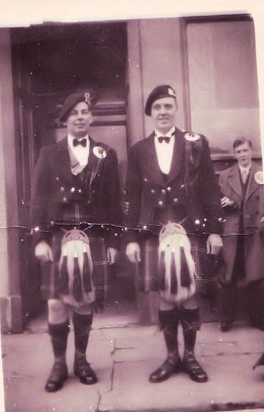 Jimmy Jackson and Bandsman with man with rosette in the background
